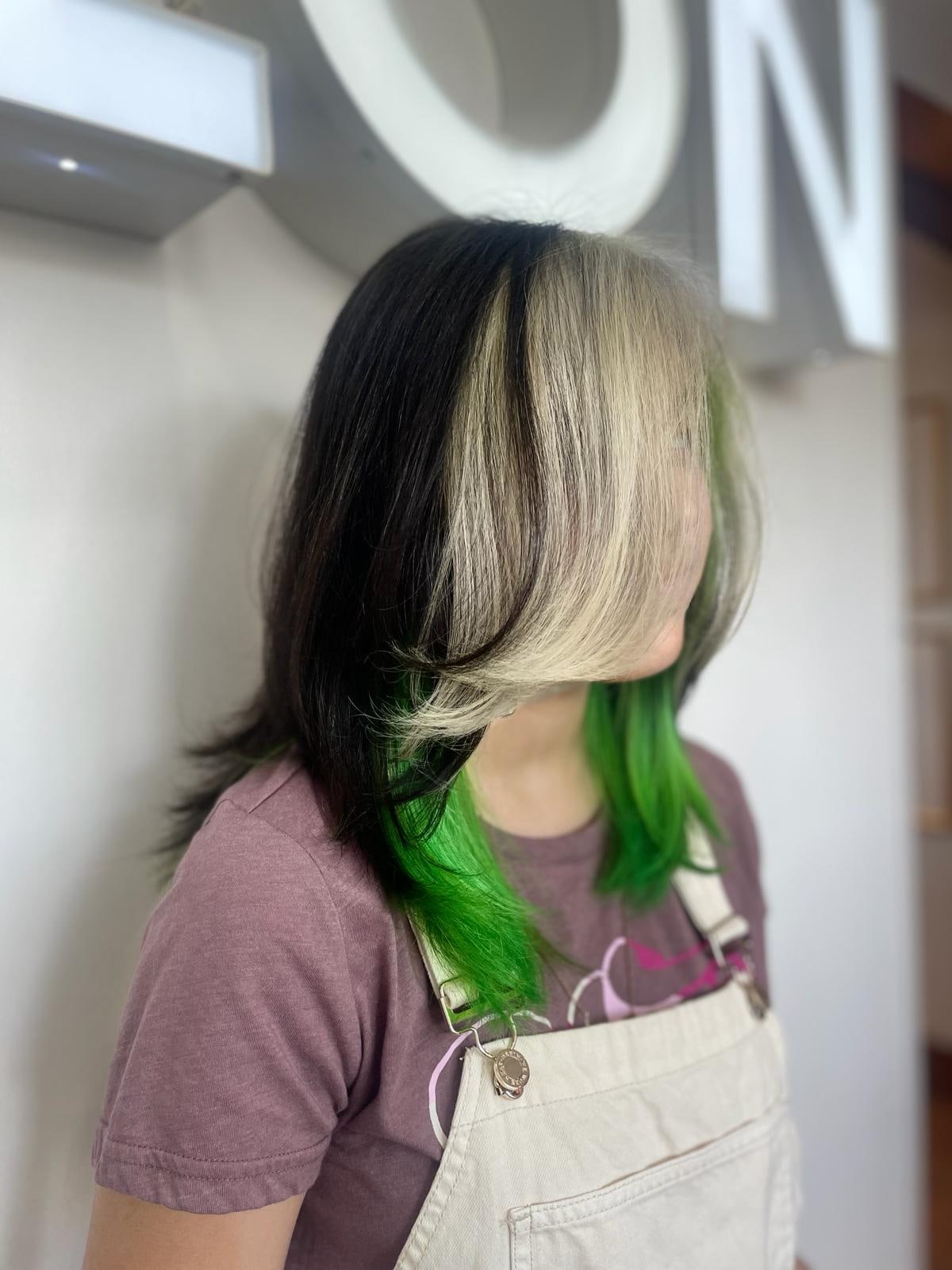 Vivid color result with platinum, black and green sections at Frenzy Salon